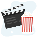 Filmklapper naast een bak popcorn in een rode bak